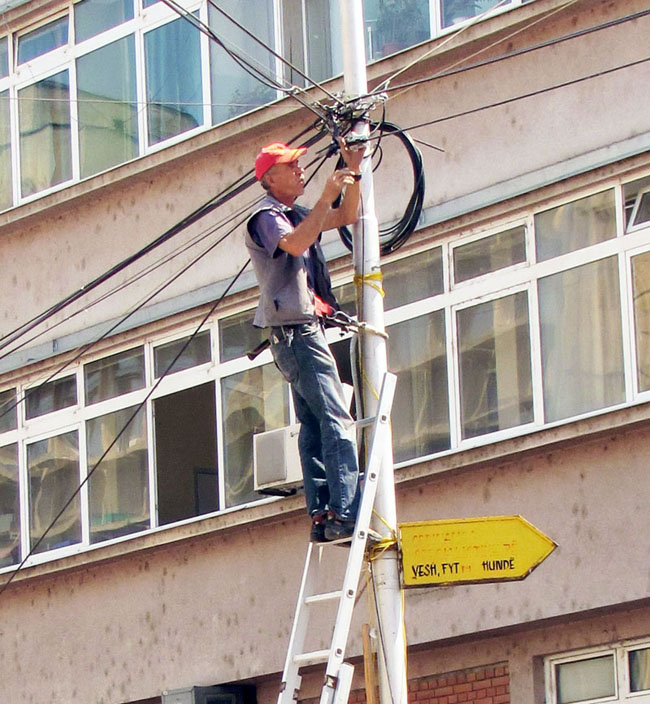 A man fixing electric pole in Mitrovica, Kosovo.